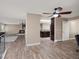Open-concept living space with hardwood floors, fireplace, and ceiling fan at 8233 W 62Nd Pl, Arvada, CO 80004