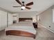 Cozy main bedroom with a large bed, soft carpet, and a ceiling fan at 8233 W 62Nd Pl, Arvada, CO 80004