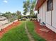 Side yard features a lawn and landscaping, with a pathway along the house at 8233 W 62Nd Pl, Arvada, CO 80004