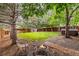 Spacious backyard features mature trees, a cozy fire pit area, and a relaxing hammock at 2905 S Deframe Way, Lakewood, CO 80228