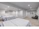 Finished basement with two beds, carpet, recessed lights, and access to bathroom and living area at 2905 S Deframe Way, Lakewood, CO 80228