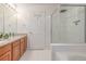 Modern bathroom featuring a shower and wood-trimmed vanity, designed for practical elegance at 2905 S Deframe Way, Lakewood, CO 80228