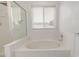 Bathroom with a bathtub and window, offering a peaceful atmosphere at 2905 S Deframe Way, Lakewood, CO 80228