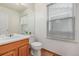 Cozy bathroom with ample natural light and wood-trimmed vanity, offering a functional design at 2905 S Deframe Way, Lakewood, CO 80228