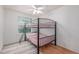 Bedroom features a black metal bunk bed with pink bedding, wood-look floors and a ceiling fan at 2905 S Deframe Way, Lakewood, CO 80228