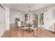 Cozy dining area with hardwood floors, backyard deck access, and an open view of living room at 2905 S Deframe Way, Lakewood, CO 80228