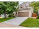 Charming two-story home with a well-maintained lawn and attached two-car garage at 2905 S Deframe Way, Lakewood, CO 80228