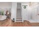 Inviting foyer with hardwood floors, white stairs, and an open view to other rooms at 2905 S Deframe Way, Lakewood, CO 80228