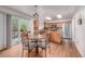 Eat-in kitchen with stainless steel appliances, wood cabinets, and backyard deck access at 2905 S Deframe Way, Lakewood, CO 80228