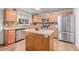 Bright kitchen featuring a central island, stainless steel appliances, and plenty of storage at 2905 S Deframe Way, Lakewood, CO 80228