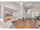 Spacious living room leading to the kitchen and staircase with hardwood floors at 2905 S Deframe Way, Lakewood, CO 80228
