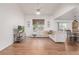 Open-concept living room with hardwood floors, a ceiling fan, and large windows at 2905 S Deframe Way, Lakewood, CO 80228