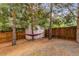Backyard features a storage shed, hammock, mature trees, and full fencing at 2905 S Deframe Way, Lakewood, CO 80228