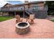 Backyard patio featuring a stone fire pit and comfortable seating perfect for entertaining at 1660 Old Antlers Way, Monument, CO 80132