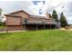 Expansive backyard featuring a large deck, lush lawn, and mature trees providing privacy at 1660 Old Antlers Way, Monument, CO 80132