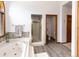 Bright bathroom featuring a jacuzzi tub, glass shower and wood look floors at 1660 Old Antlers Way, Monument, CO 80132