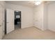 Bright bedroom showcasing neutral carpet, ceiling fan, and access to additional living space at 1660 Old Antlers Way, Monument, CO 80132