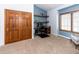 Bedroom features a home office nook with floating shelves and natural light at 1660 Old Antlers Way, Monument, CO 80132