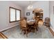 Dining area featuring a wood table, a chandelier, and a view into an adjacent kitchen at 1660 Old Antlers Way, Monument, CO 80132