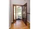 Inviting foyer with a wood door, side panel window, and hardwood flooring at 1660 Old Antlers Way, Monument, CO 80132