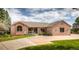 Charming brick home with a spacious driveway, well-maintained lawn, and inviting front porch at 1660 Old Antlers Way, Monument, CO 80132