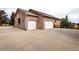 Spacious three-car garage and a long driveway that provides ample parking space at 1660 Old Antlers Way, Monument, CO 80132
