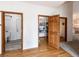 Hallway with doors leading to laundry, pantry, and bathroom at 1660 Old Antlers Way, Monument, CO 80132