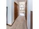 Hallway provides access to the bedroom's closets and an ensuite bathroom with a soaking tub at 1660 Old Antlers Way, Monument, CO 80132