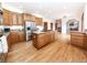 Bright kitchen showcasing a center island cooktop, stainless steel appliances, and wood flooring at 1660 Old Antlers Way, Monument, CO 80132