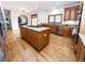 Bright kitchen showcasing a center island cooktop, stainless steel appliances, and wood flooring at 1660 Old Antlers Way, Monument, CO 80132