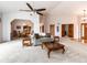 Open-concept living room with comfortable seating, a ceiling fan, and easy access to the dining area at 1660 Old Antlers Way, Monument, CO 80132