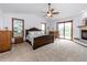 Spacious main bedroom offers a ceiling fan, walk-out deck, fireplace and generous natural light at 1660 Old Antlers Way, Monument, CO 80132