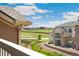 Balcony with views of nearby apartments and open fields under a blue sky with clouds at 7440 S Blackhawk St # 7-303, Englewood, CO 80112