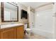 Bathroom with wood vanity, large mirror, and shower over tub at 7440 S Blackhawk St # 7-303, Englewood, CO 80112