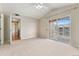 A bright bedroom with a ceiling fan and access to a private balcony at 7440 S Blackhawk St # 7-303, Englewood, CO 80112