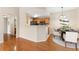 Open dining space and kitchen featuring stainless appliances, wood cabinets, and hardwood flooring at 7440 S Blackhawk St # 7-303, Englewood, CO 80112
