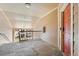 A second floor apartment hallway with a red door and metal railing at 7440 S Blackhawk St # 7-303, Englewood, CO 80112