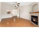 Open-concept living room with a fireplace and views of the kitchen and entryway for a modern flow at 7440 S Blackhawk St # 7-303, Englewood, CO 80112