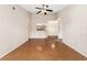 Open living space with hardwood floors, high ceilings, and view into the kitchen and entry at 7440 S Blackhawk St # 7-303, Englewood, CO 80112