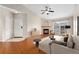 Inviting living room boasts a cozy fireplace, modern ceiling fan, and access to outdoor balcony at 7440 S Blackhawk St # 7-303, Englewood, CO 80112