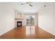Spacious living room with hardwood floors, fireplace and sliding doors to balcony with natural light at 7440 S Blackhawk St # 7-303, Englewood, CO 80112