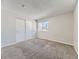 Bright bedroom with neutral walls, carpet, double closet and window letting in natural light at 14006 E Utah Cir, Aurora, CO 80012