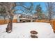 Spacious backyard with deck, firepit, and snow at 16193 E Dickenson Pl, Aurora, CO 80013