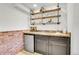 Basement bar with shelving and a mini-fridge at 16193 E Dickenson Pl, Aurora, CO 80013