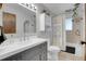 Stylish bathroom with modern vanity, mirror, shower, and neutral tile at 16193 E Dickenson Pl, Aurora, CO 80013