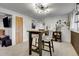 Bright dining area with modern light fixture and a view to wet bar at 16193 E Dickenson Pl, Aurora, CO 80013