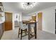 Bright dining area with modern light fixture and a view to stairway at 16193 E Dickenson Pl, Aurora, CO 80013