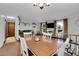 Bright dining area with wooden table and chairs next to living room at 16193 E Dickenson Pl, Aurora, CO 80013