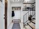 Bright entryway with coat closet, bench, and staircase at 16193 E Dickenson Pl, Aurora, CO 80013