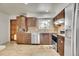 Cozy kitchen with modern appliances, stylish backsplash, and granite counters, and wood grain tile floor at 16193 E Dickenson Pl, Aurora, CO 80013